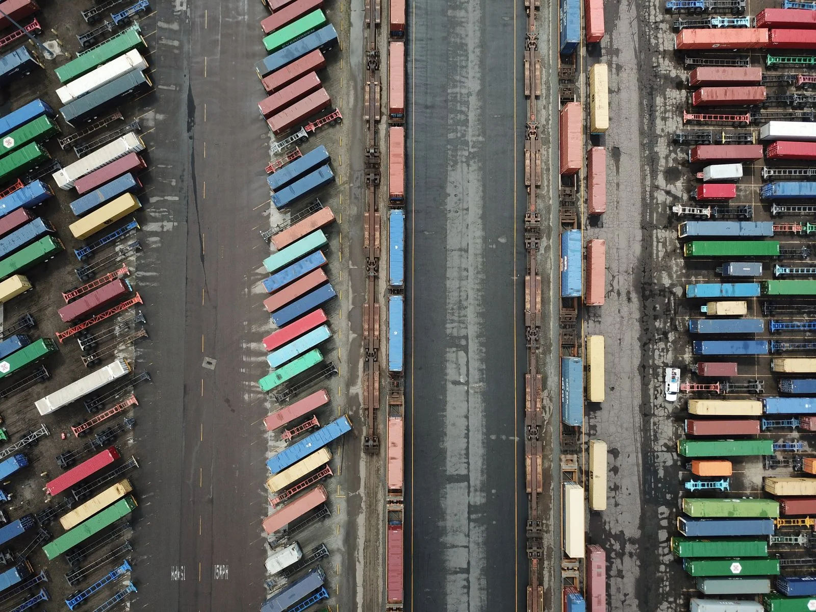 Illustrative stock photograph of containers, freight trailers and rail tracks at a cargo terminal